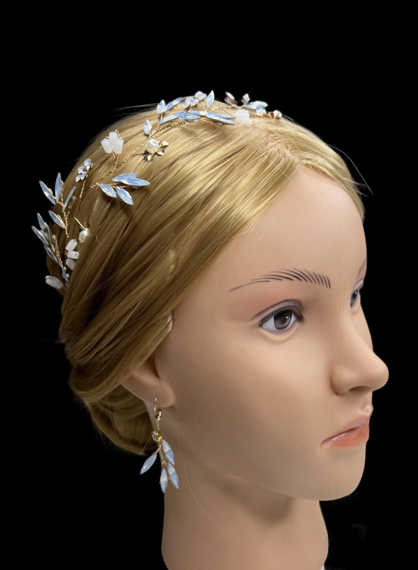 Mannequin head with a decorative headband on a black background