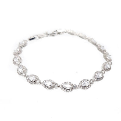 Silver bracelet with clear stones on a white background