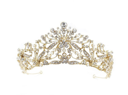 Gold tiara with intricate design and crystals on a white background
