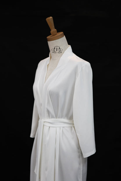 White robe on a mannequin against a black background