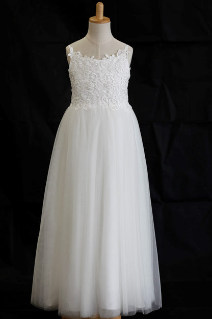 White lace dress on a mannequin against a black background