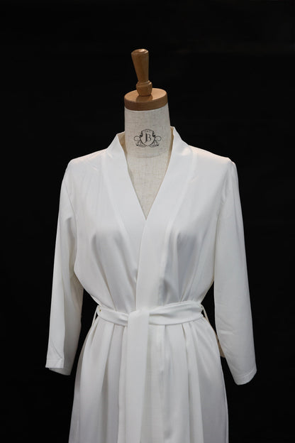 White robe on a mannequin against a black background