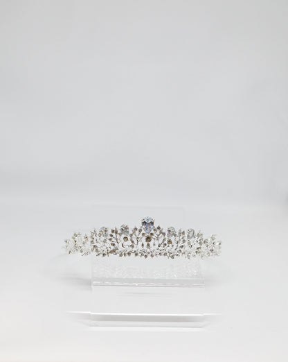 Diamante tiara on a white stand against a light gray background