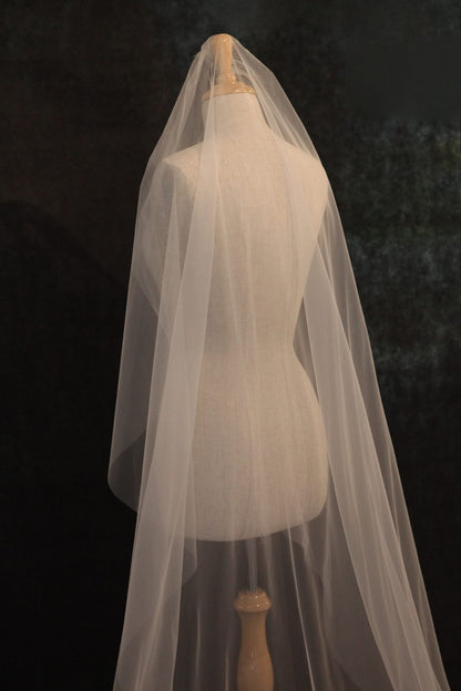 White wedding veil on a mannequin against a dark background