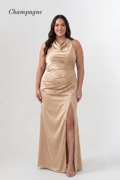 A woman modeling a floor-length champagne satin gown with a draped cowl neckline, gathered waist, and high front slit, against a light gray studio background. The word 'Champagne' appears in the upper left.