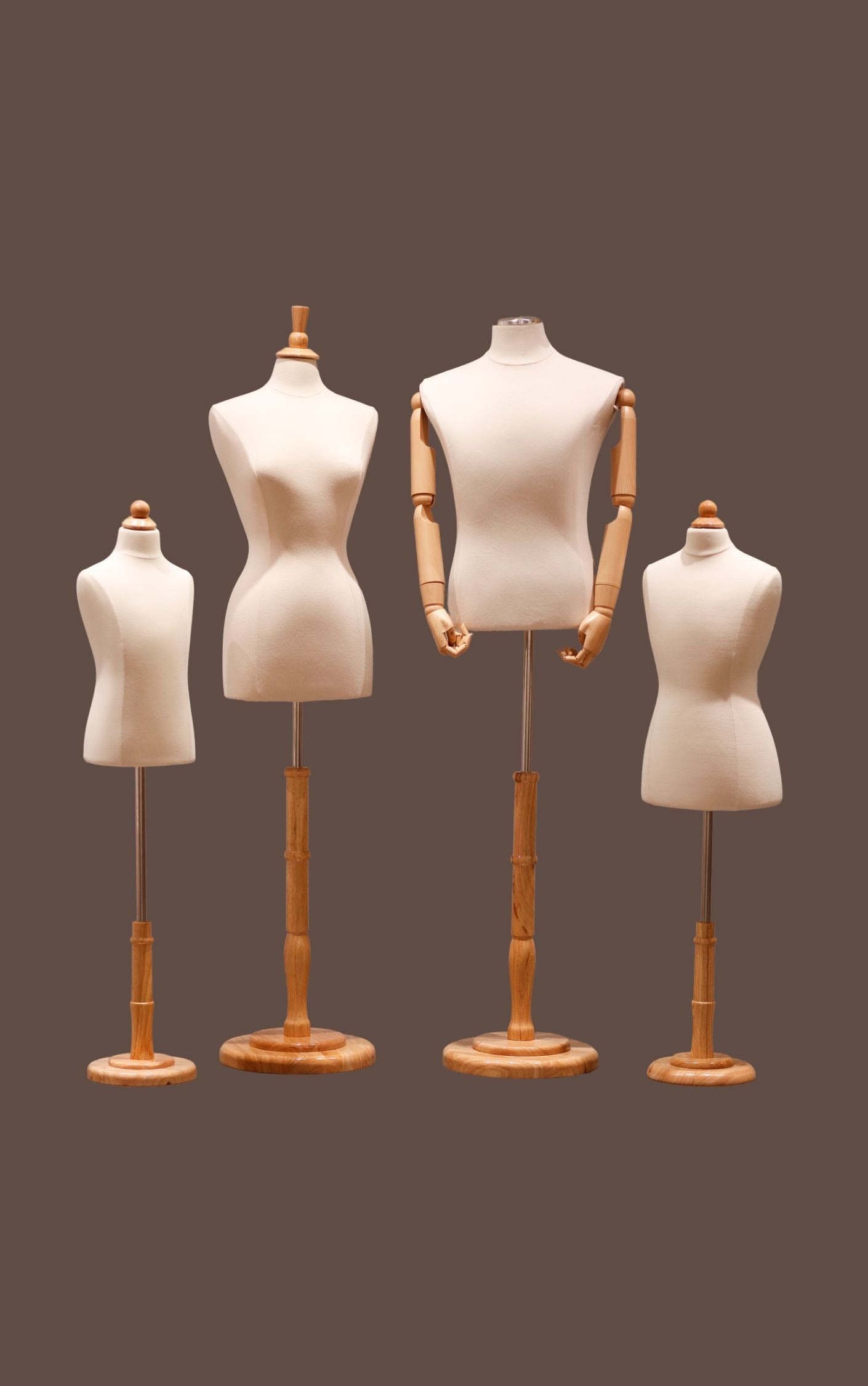 Set of four mannequins with wooden stands on a brown background