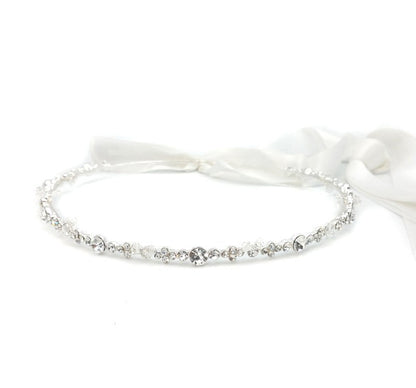 Silver bracelet with small stones on a white background