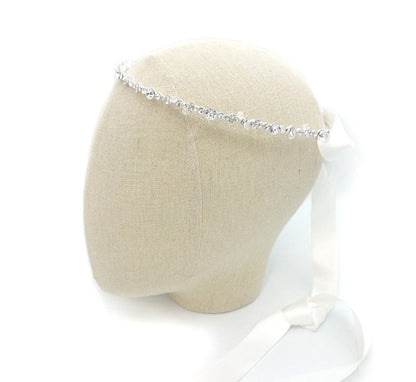 Silver headband on a mannequin head with a white background