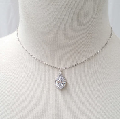 Silver necklace with a teardrop-shaped pendant on a mannequin