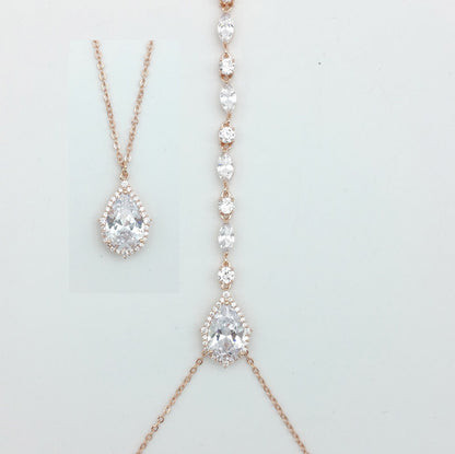 Rose gold necklaces with pear-shaped diamond pendants on a light gray background