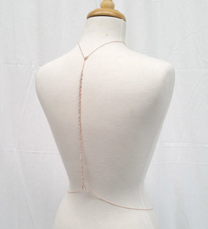 Mannequin wearing a delicate gold chain necklace on a white background