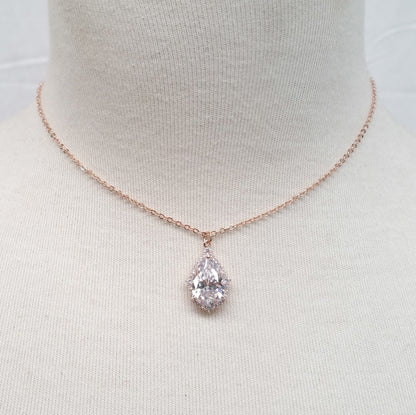 Rose gold necklace with a clear pendant on a mannequin