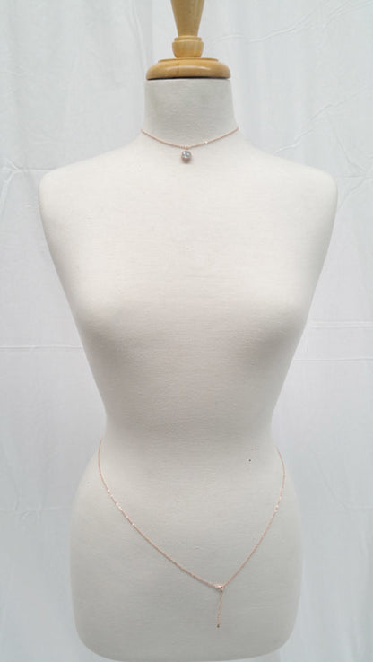 Mannequin wearing a delicate gold necklace on a white background