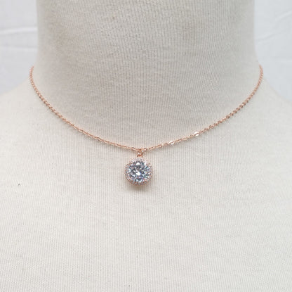 Rose gold necklace with a diamond pendant on a mannequin bust