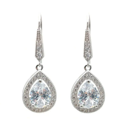 Teardrop-shaped earrings with clear gemstones on a white background