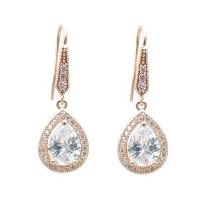 Rose gold teardrop earrings with clear gemstones on a white background