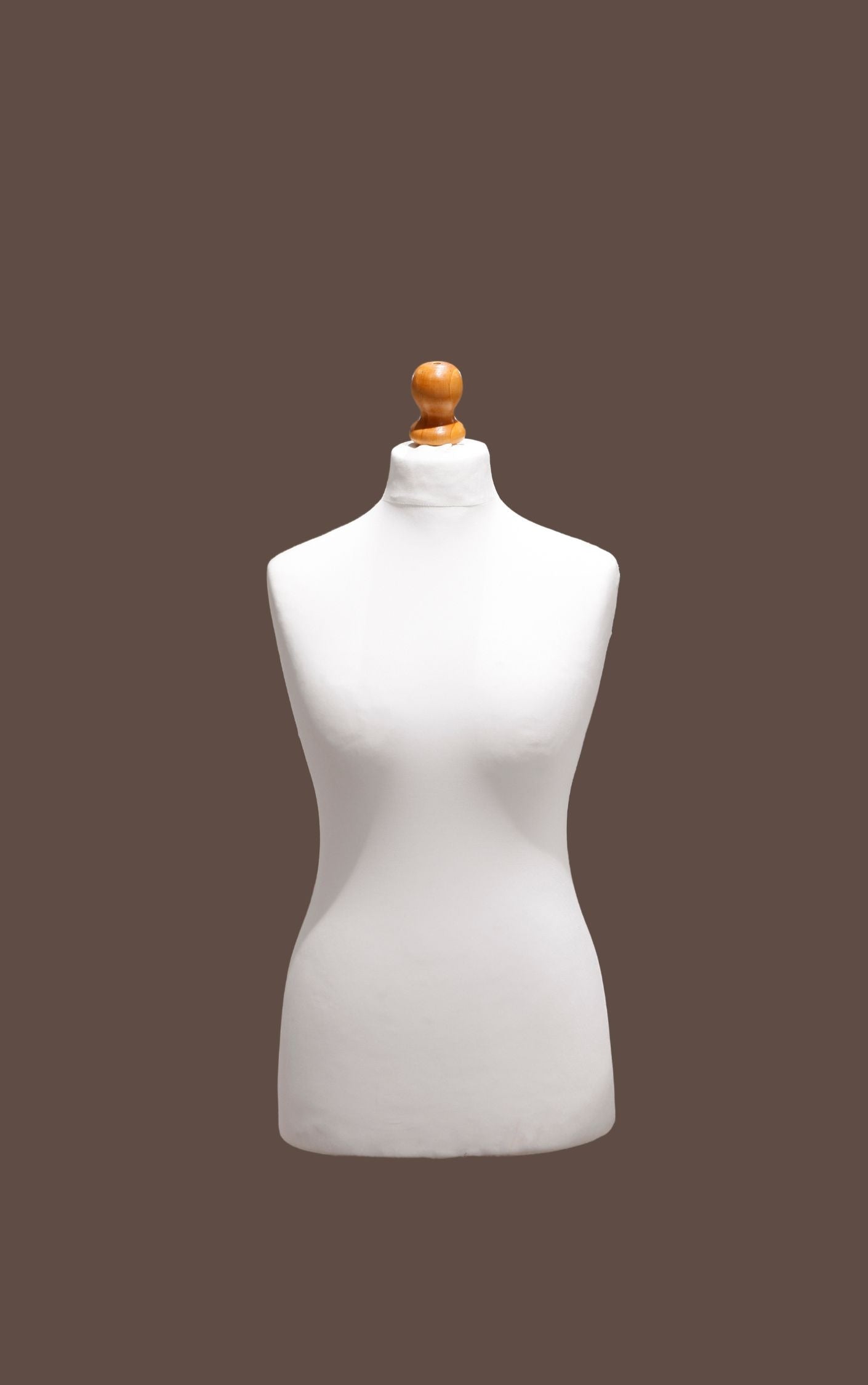 White mannequin torso with a wooden head on a brown background