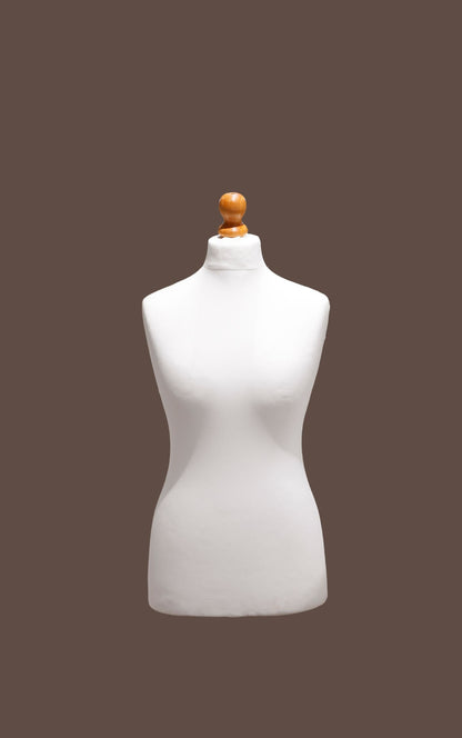 White mannequin torso with a wooden head on a brown background