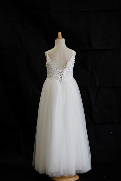 White lace dress on a mannequin against a black background
