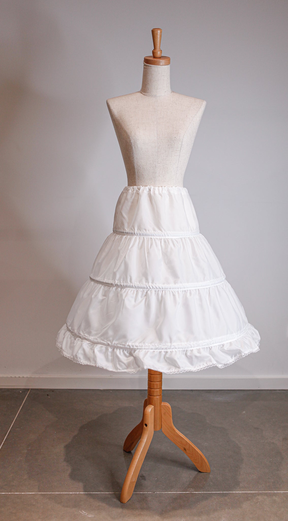 White petticoat on a mannequin with a plain background