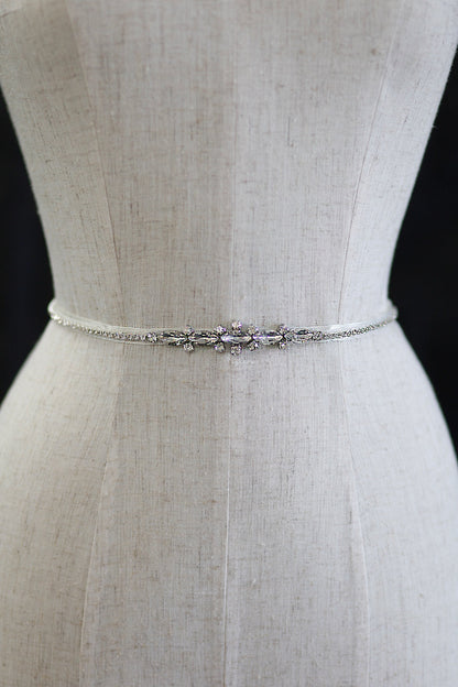 Silver belt with crystals on a mannequin against a black background