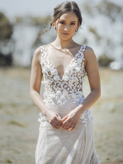 Woman wearing a floral wedding dress in an outdoor setting