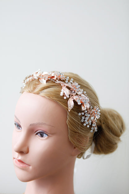 Mannequin head with a decorative headband on a plain background