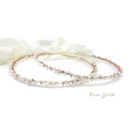 Rose gold headband with pearls and crystals on a white background