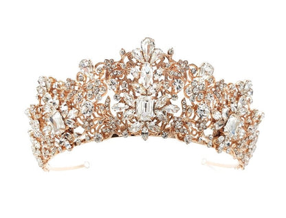 Rose gold tiara with intricate design and clear stones on a white background
