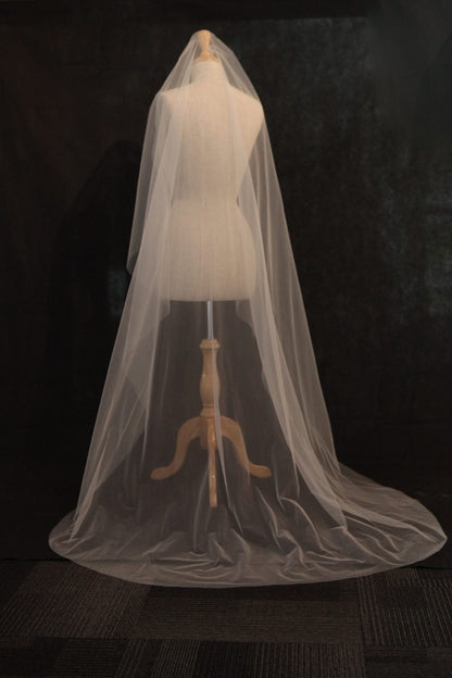 White wedding veil on a mannequin against a dark background