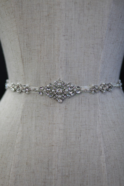 Silver beaded belt on a mannequin with a neutral background