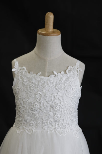 White lace dress on a mannequin against a black background