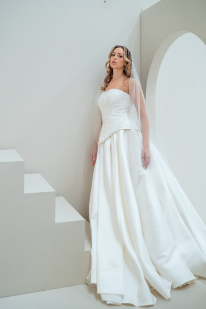 Woman in a white wedding dress standing on a staircase