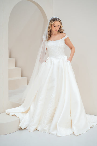 Woman in a white wedding dress standing in a minimalistic setting