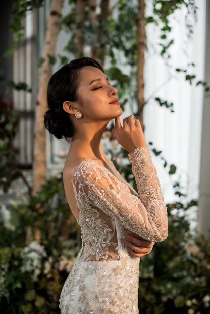 Woman in a lace dress standing among trees