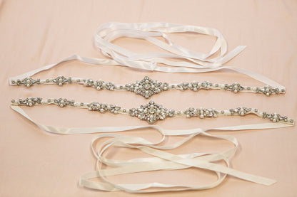Three decorative belts with ribbons on a beige background