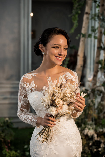 Bride holding a bouquet of flowers in an outdoor setting