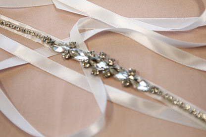 Bridal belt with crystals and ribbons on a neutral background