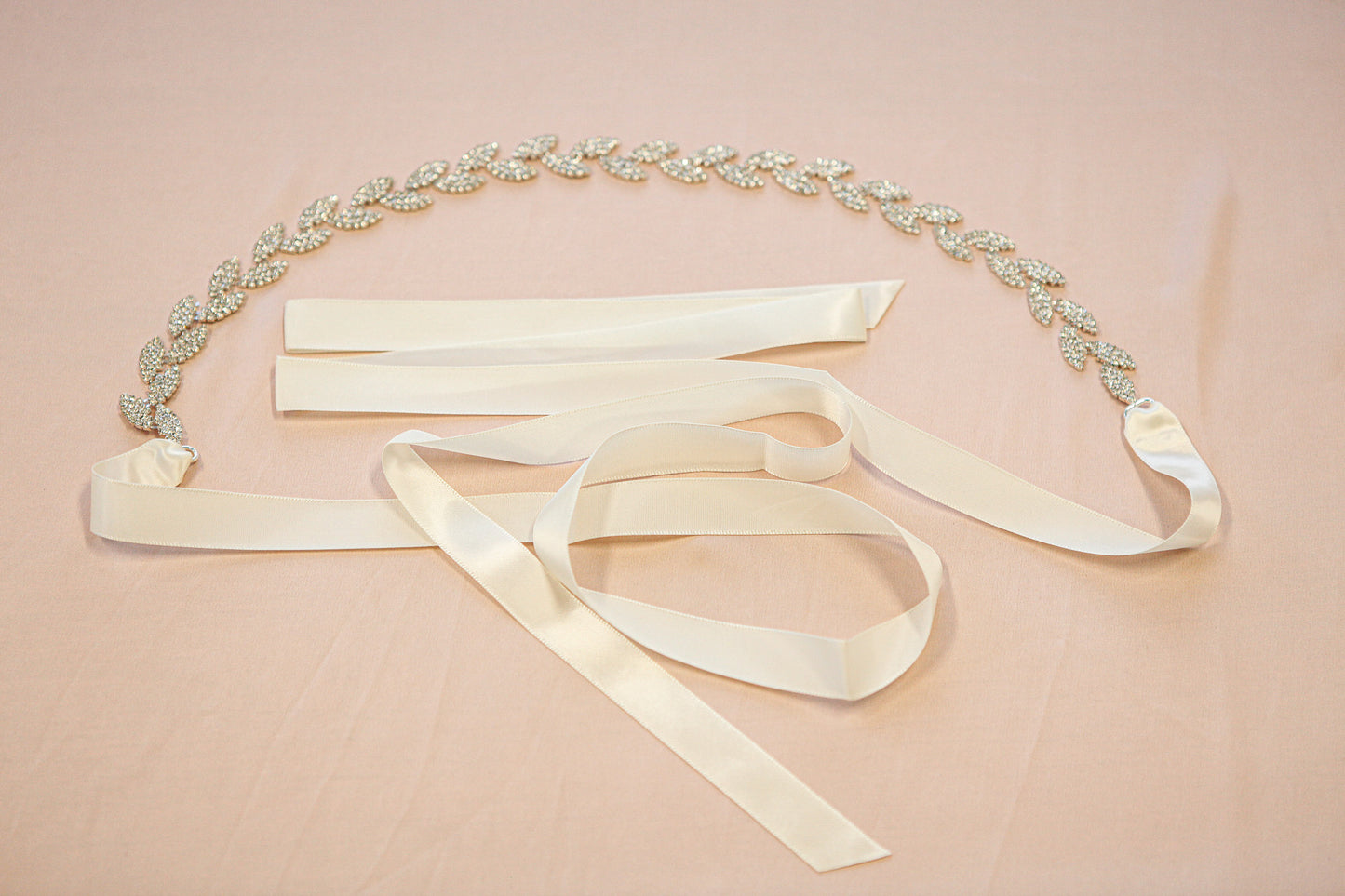 Decorative belt with ribbons on a pink background