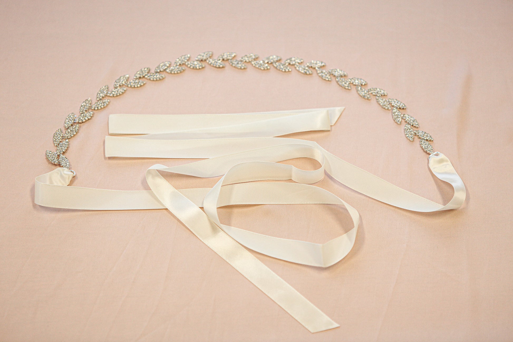 Decorative belt with ribbons on a pink background