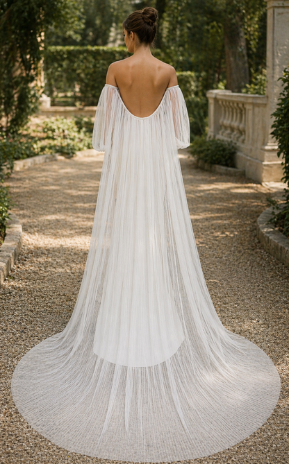Woman in a white off-shoulder dress walking in a garden setting