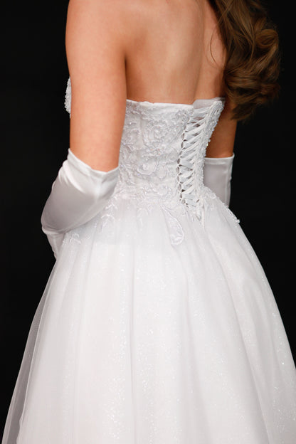 White wedding dress with lace detailing and a black background