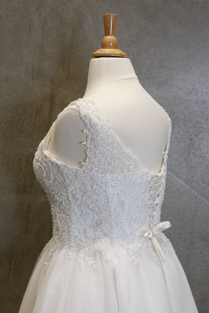 White lace dress on a mannequin against a gray background