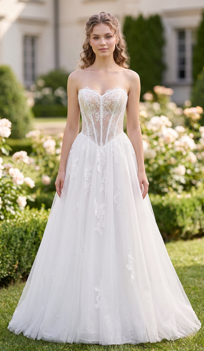 Woman in a white wedding dress standing in a garden with flowers and a building in the background