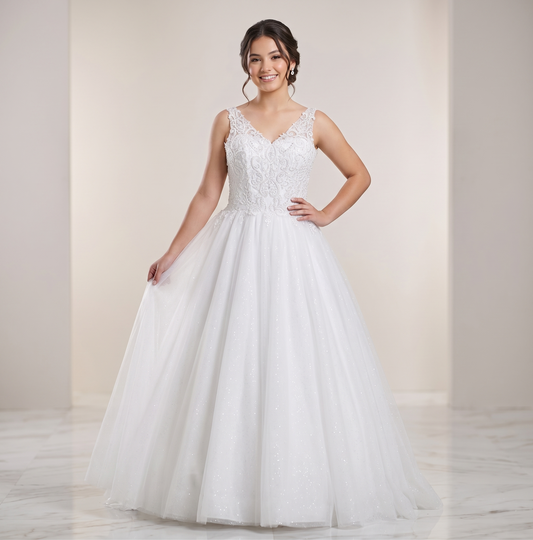 Woman wearing a white wedding dress with lace bodice and flowing skirt against a plain background