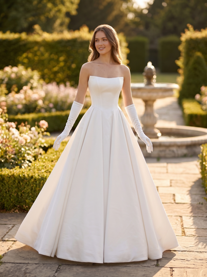 Woman in a white wedding dress standing in a garden setting