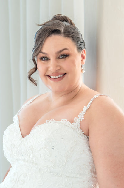 Woman in a white wedding dress with a neutral background
