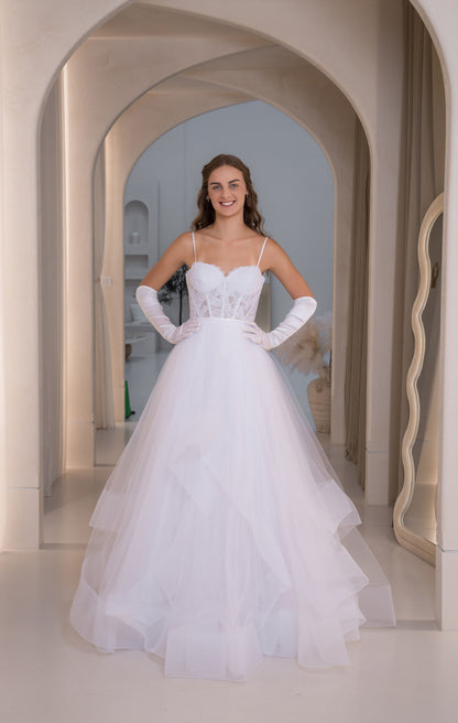 Woman in a white wedding dress standing in an archway