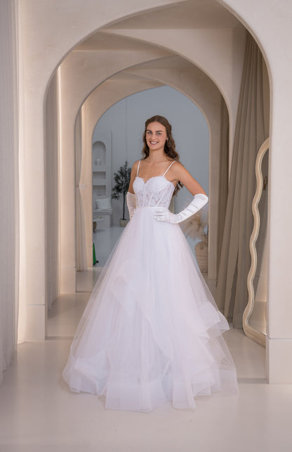 Woman in a white wedding dress standing in an archway