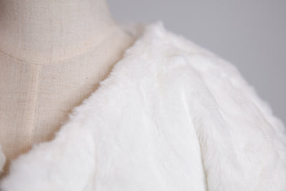 Close-up of a textured white fabric on a mannequin with a neutral background
